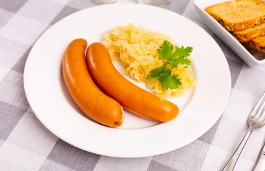 Gordijnen Appetizing sausages with side dish of sauerkraut © JackF