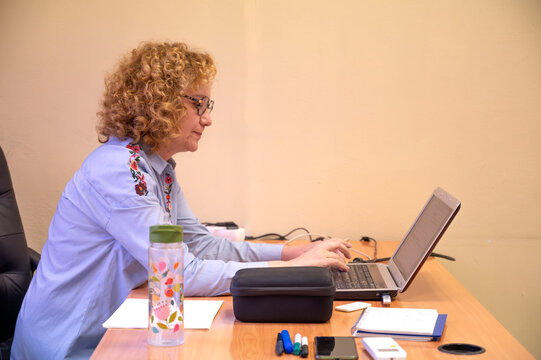 Mature woman studying at a computer desk