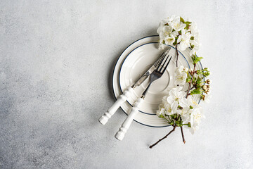 Spring table setting with blossom and vintage cutlery
