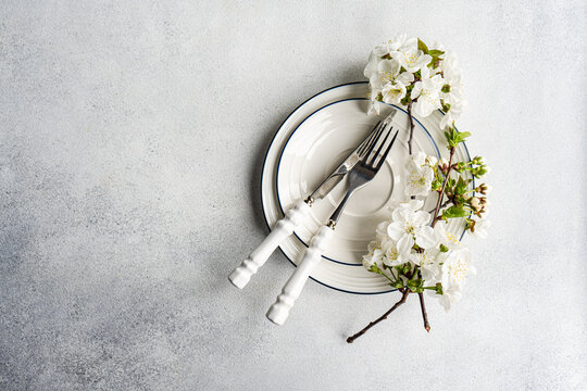 Spring table setting with blossom and vintage cutlery