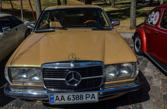 Executive luxury beige German Mercedes-Benz 230 CE Automatic, 1982 at classic car show in Kyiv