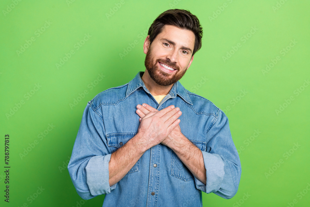 Sticker Photo of good mood handsome guy wear denim jacket smiling arms heart empty space isolated green color background