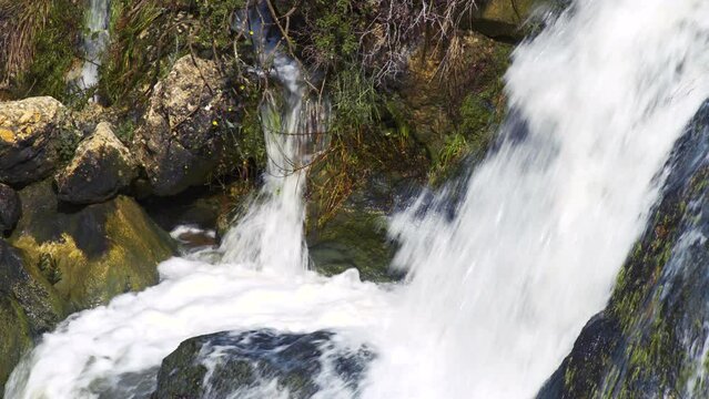 water falling over and on rocks 4K 