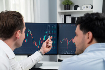 Successful stock exchange traders focusing on high profit chart investment on dynamic database,...