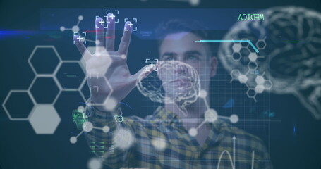 Caucasian male colleague wearing plaid shirt interacting with digital interfaces