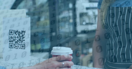 Middle-aged Caucasian business partner holding coffee cup, sitting near a QR code