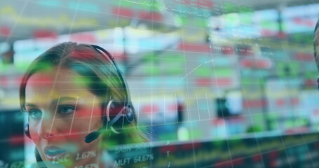 Caucasian female intern wearing headset, looking at digital screens