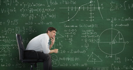 Caucasian boy ponders math equations on chalkboard - 788804676