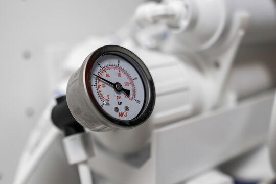 Pressure gauge shows the pressure in the reverse osmosis system. 