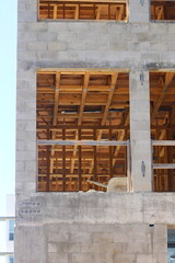 Exterior of a concrete building with wood paneling under construction
