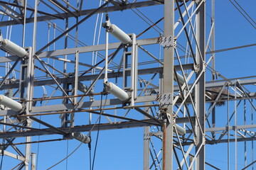 Steel electrical power grid under a bright blue sky