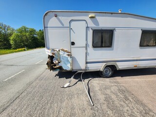 Vintage White Small Travel Trailer with Significant Damage on Rear, Perfect for Fixer-Upper...