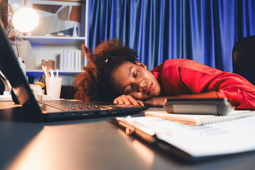 African woman freelancer feeling tried and take a nap on desk around by laptop and stationary,...