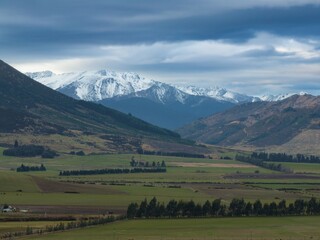 Fototapeta na wymiar Aerial: View of the Southern Alps and farmland from Mossburn, Southland, New Zealand.