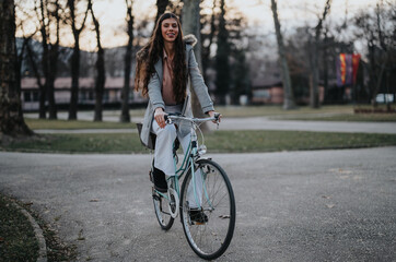 An empowered business lady enjoys an eco-friendly commute, cycling through a serene park scene.