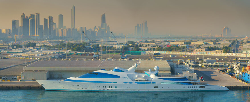 Abu Dhabi, United Arab Emirates - Jan 10 2024, Panoramic view of downtown skyscrapers, in the foreground the port with the moored super yacht YAS in the daytime, Abu Dhabi, United Arab Emirates 