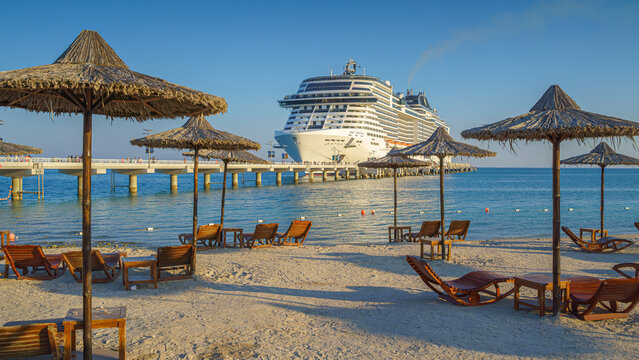 Sir Bani Yas island, United Arab Emirates - Jan 11 2024, Panoramic view of the MSC Virtuosa cruise ship in the foreground is a beach with sun loungers, Sir Bani Yas, Abu Dhabi, United Arab Emirates 