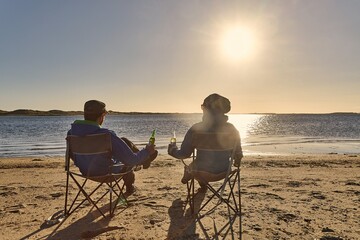 Relaxing at the beach in camping chairs - 788815841