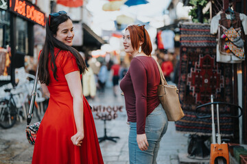 Two young women in stylish outfits spend their free time together, exploring the vibrant street markets of the city on a sunny weekend.