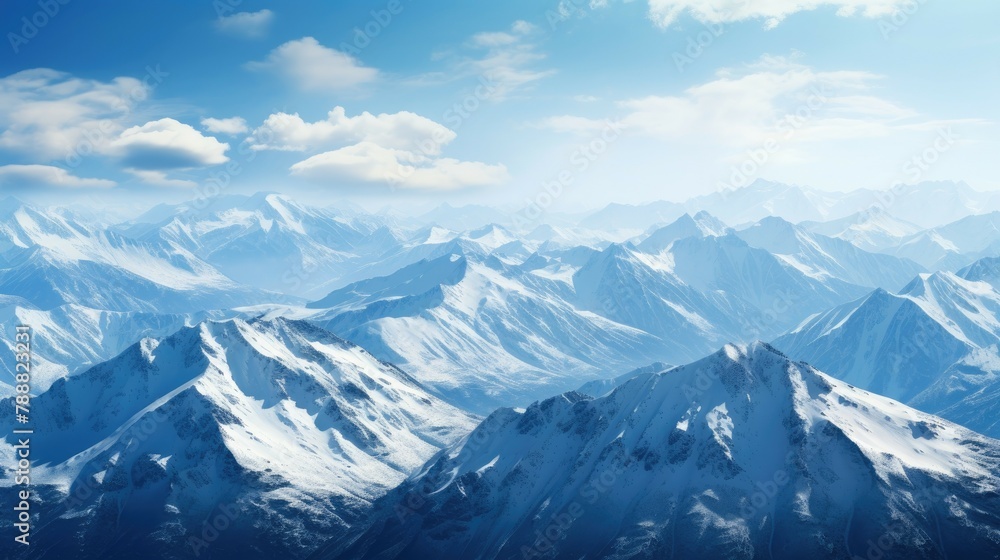 Poster the image is of snow-capped mountains with a blue sky and clouds in the background. the mountains ar