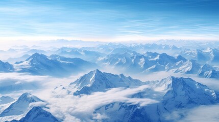 This is a beautiful landscape photograph of a mountain range. The mountains are covered in snow and the sky is a clear blue.