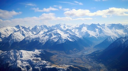 Fototapeta premium This is a beautiful landscape photograph of the snow-capped peaks of a mountain range.