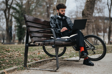 Focused male business entrepreneur using a laptop in a casual outdoor setting, epitomizing mobile office concepts.