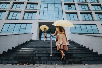 Friends reunite with a warm greeting outside an office building, shields from the rain with bright umbrellas, capturing a moment of city life.