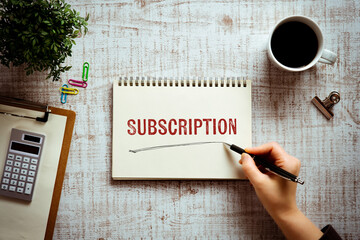 There is notebook with the word Subscription. It is as an eye-catching image.