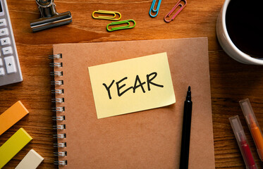 There is sticky note with the word YEAR. It is as an eye-catching image.
