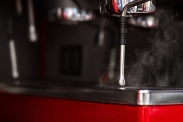 Part of a coffee machine. Steamer with steam coming from it