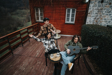 Two friends unwind with a guitar on a cozy cabin porch, exuding a serene, content ambiance in a rustic setting.