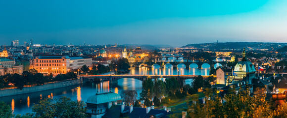 Prague, Czech Republic. Evening Panoramic View Of Evening Cityscape In Night Lighting. Charles Bridge, Manes Bridge, Straka Academy.  Famous Landmarks, UNESCO World Heritage