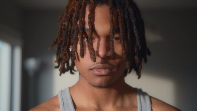 Portrait of a young man with dreadlocks at sunset. Slow motion. 