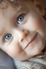 A portrait of a baby with a playful expression. The eyes are twinkling and the lips are curled into a smile. The baby is mischievous and fun-loving.