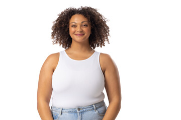 Biracial young female plus size model standing on white background, wearing white tank top and jeans - 788840036