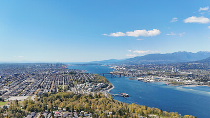 Beautiful aerial view of the skyline of Vancouver and North Burnaby next to the Burrard Inlet during a spring season in British Columbia, Canada © StandbildCA