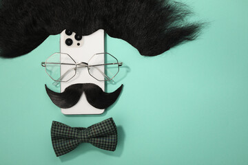 Flat lay composition with artificial moustache and glasses on turquoise background, space for text