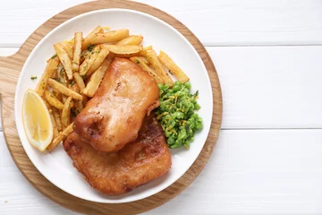 Fotobehang Tasty fish, chips, peas and lemon on white wooden table, top view © New Africa