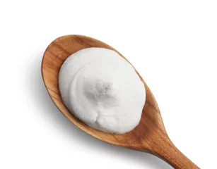 Schilderijen op glas Wooden spoon with sour cream isolated on white, top view © New Africa