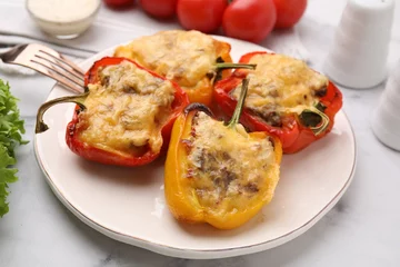 Gordijnen Delicious stuffed peppers and fork on white table, closeup © New Africa