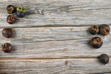 Mangosteen fruit on old wood background. The Queen of Fruits, Tropical fruit with sweet juicy white...