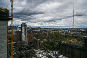 A panoramic perspective of Brooklyn's diverse architecture, with the Hudson River's edge meeting an expansive sky, showcasing the vibrant life along New York's famous waterways.