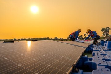 Photovoltaic engineers work on floating photovoltaics. workers Inspect and repair the solar panel equipment floating on water. Engineer working setup Floating solar panels Platform system on the lake.