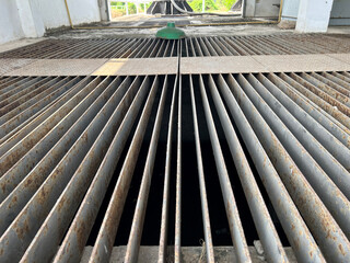 Grille of the drainage system on the pedestrian sidewalk.