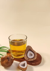 Zuriat tea in glass with zuriat fruit and palm leaf.