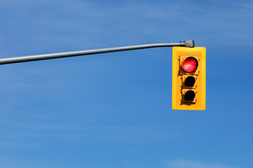 a traffic signal light with the red STOP light lit