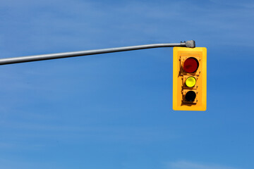 a traffic signal light with the yellow caution light lit