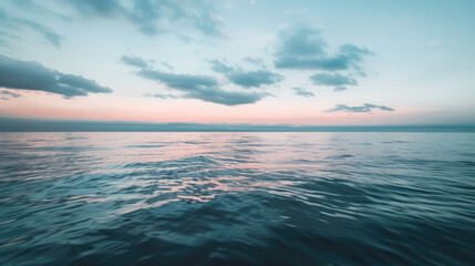 Fototapeta premium Gentle dawn over tranquil sea with minimalist clouds for serene panoramic background