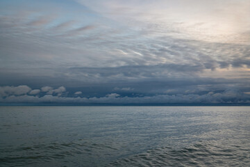 View of the Black Sea on the coast of Sochi against the sunset sky, Sochi, Krasnodar Krai, Russia